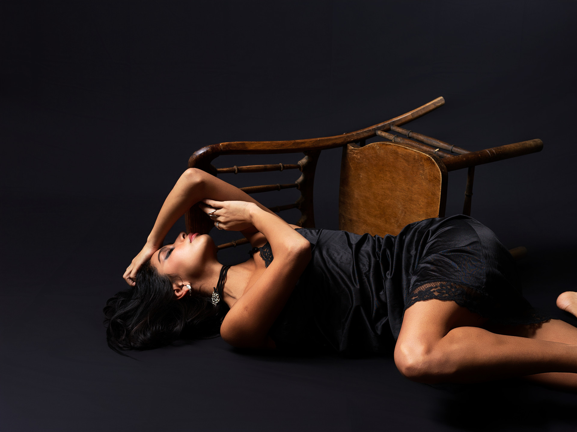 Carolina holds a luminous, restrained pose inside a dark editorial frame.