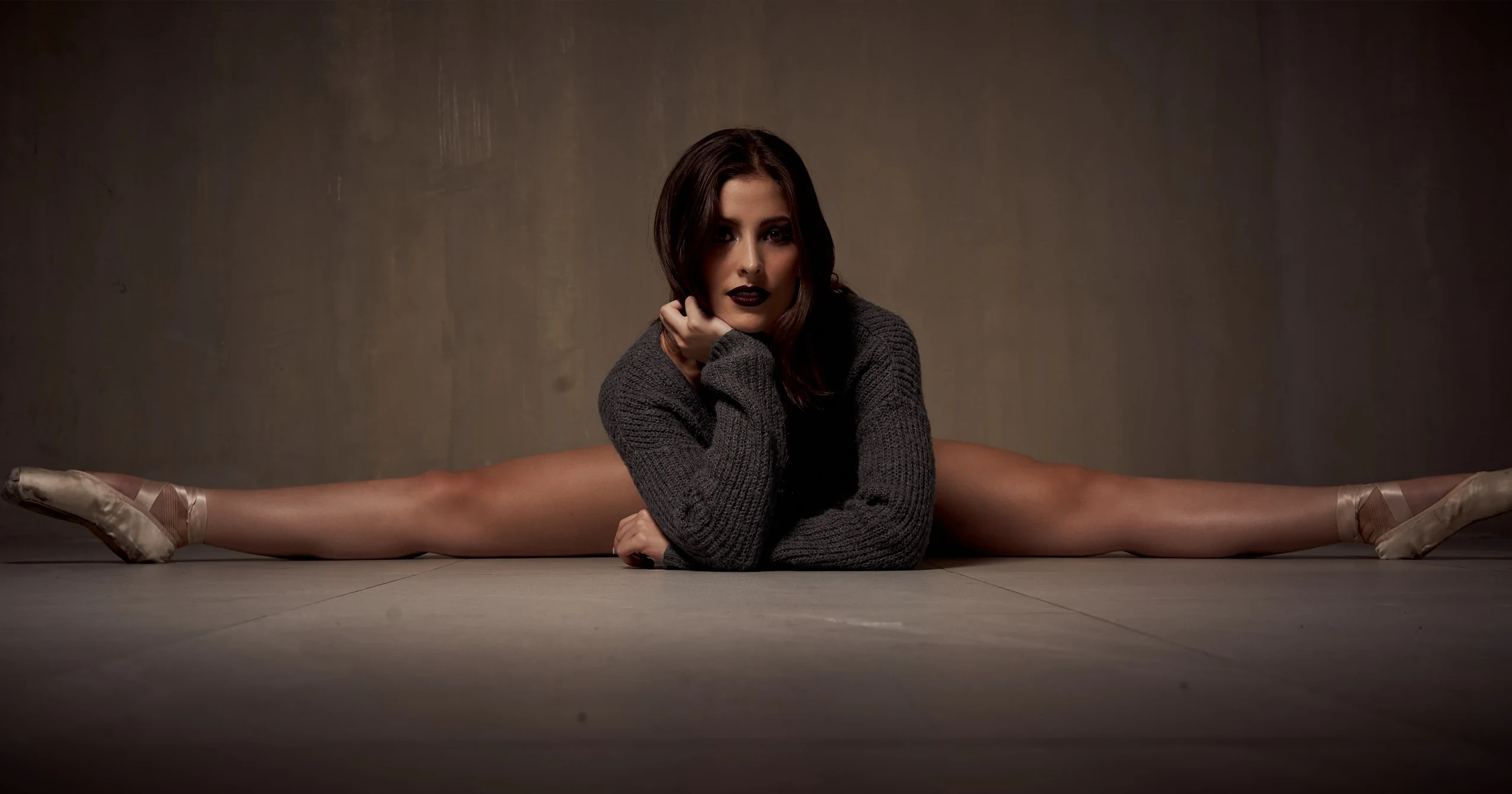 Paola holds a close-cropped portrait with sharp, restrained intensity.